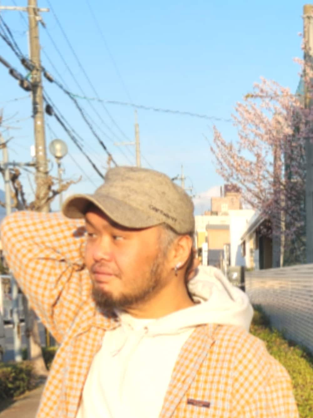 ホワイト系のスニーカー、ブラウン系のカーゴパンツ、グレー系のパーカーを着用したメンズの春コーディネートの4枚目の写真