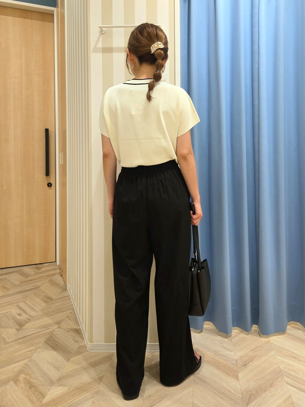 ホワイト系のニット/セーター、ブラック系のその他パンツ、ブラック系のサンダルを着用したレディースの夏コーディネートの3枚目の写真