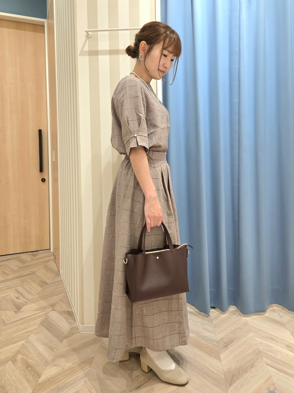 ベージュ系のシャツ/ブラウス、ベージュ系のスカート、ベージュ系のパンプスを着用したレディースの秋コーディネートの3枚目の写真