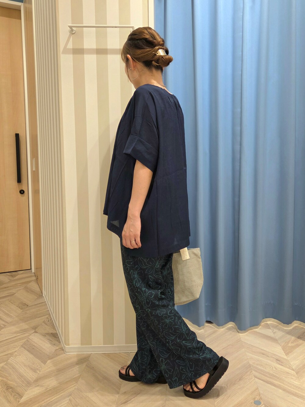 ブルー系のその他パンツ、ブラック系のサンダル、グレー系のトートバッグを着用したレディースの夏コーディネートの3枚目の写真