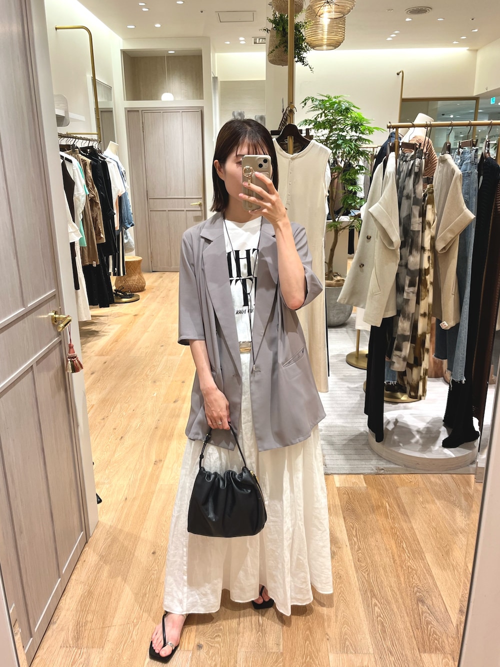 ホワイト系のスカート、ホワイト系のTシャツ/カットソー、グレー系のその他アウターを着用したレディースの夏コーディネートの2枚目の写真