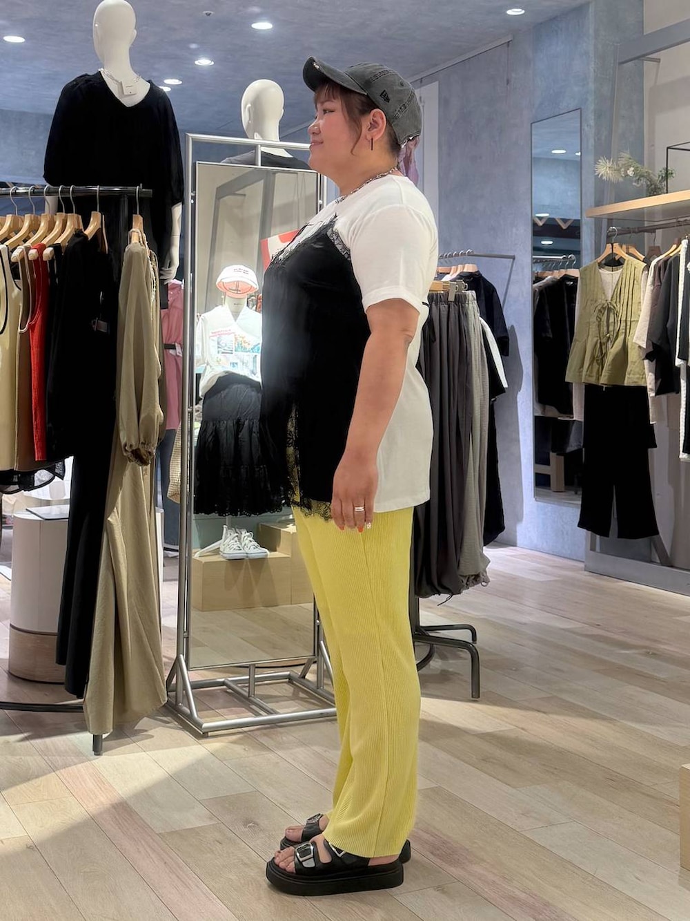 イエロー系のその他パンツ、ブラック系のサンダル、ホワイト系のTシャツ/カットソーを着用したレディースの春コーディネートの2枚目の写真