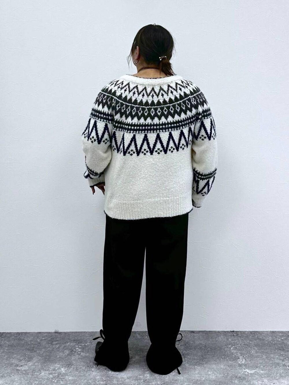 ブラック系のパンプス、ホワイト系のカーディガン/ボレロ、ブラック系のその他パンツを着用したレディースの秋コーディネートの3枚目の写真