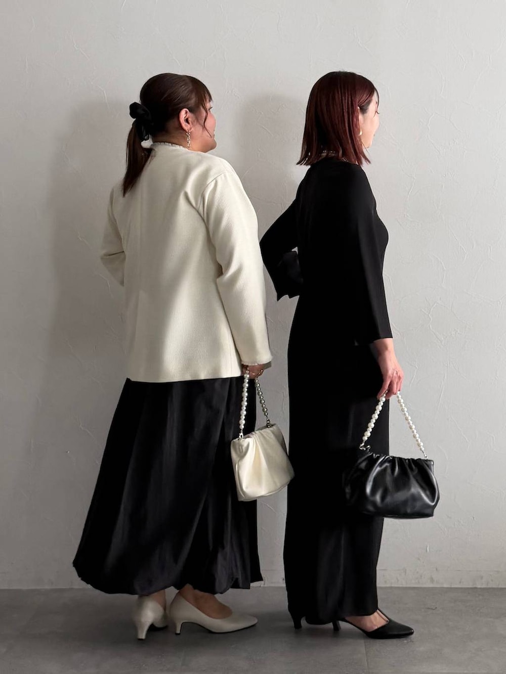 ホワイト系のTシャツ/カットソー、ホワイト系のノーカラージャケット、ブラック系のスカートを着用したレディースの秋コーディネートの2枚目の写真