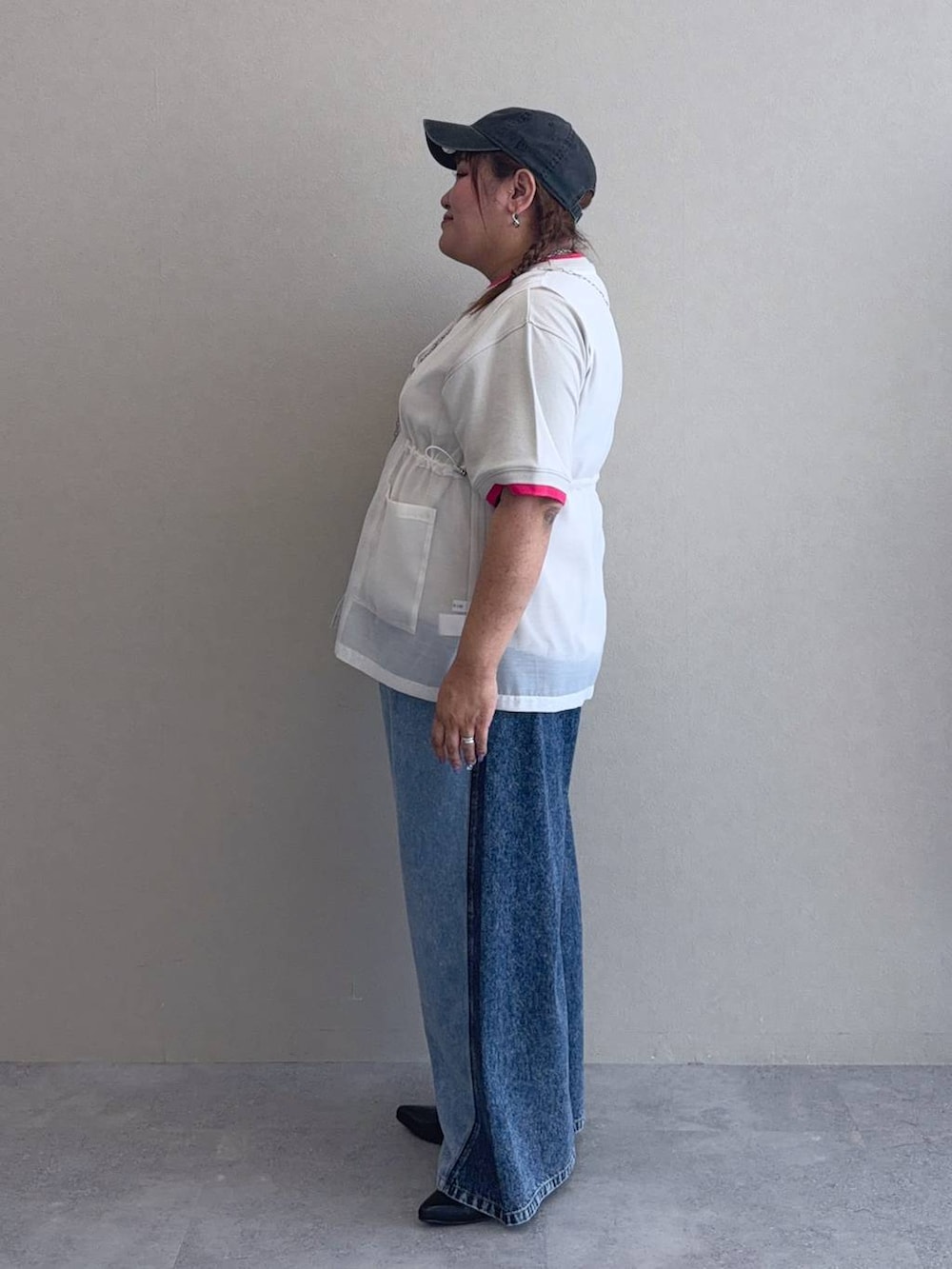 ブルー系のデニムパンツ、シルバー系のショルダーバッグ、ブラック系のパンプスを着用したレディースの夏コーディネートの2枚目の写真
