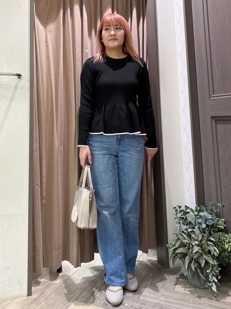 ブラック系のニット/セーター、ブルー系のデニムパンツ、グレー系のトートバッグを着用したレディースの春コーディネートの4枚目の写真