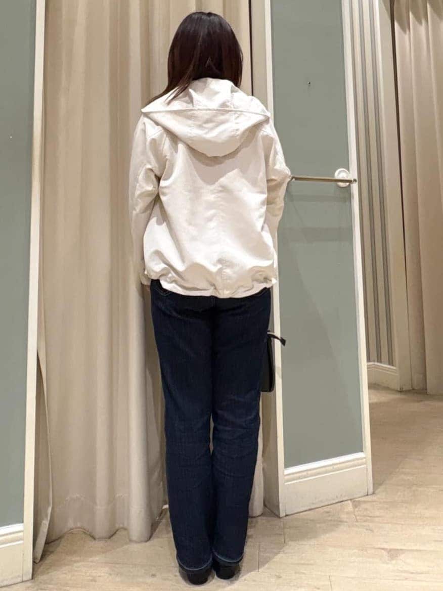 ホワイト系のブルゾン、ピンク系のニット/セーター、ブルー系のデニムパンツを着用したレディースの冬コーディネートの9枚目の写真