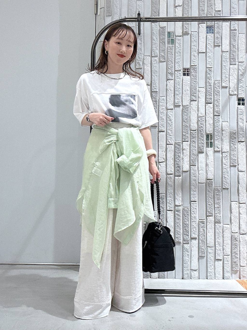 ブラック系のショルダーバッグ、ホワイト系のTシャツ/カットソー、その他のサンダルを着用したレディースの夏コーディネートの2枚目の写真