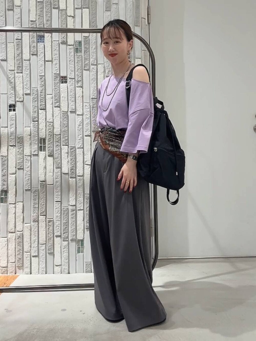 パープル系のTシャツ/カットソー、ブラック系のサンダル、グレー系のその他パンツを着用したレディースの夏コーディネートの2枚目の写真