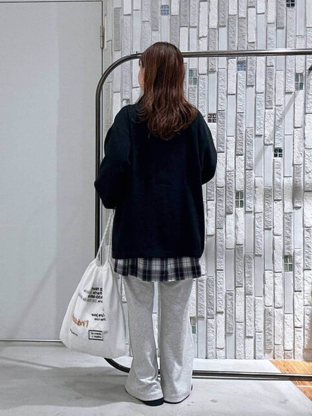 ホワイト系のTシャツ/カットソー、グレー系のスウェットパンツ、ブラック系のその他シューズを着用したレディースの春コーディネートの4枚目の写真