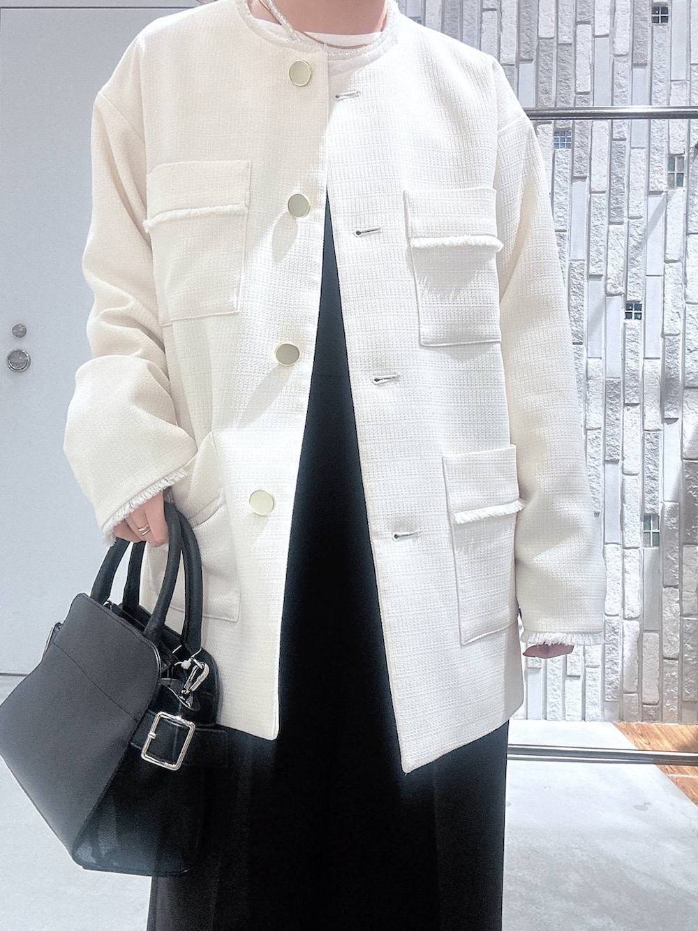 ブラック系のサロペット/オーバーオール、ホワイト系のTシャツ/カットソー、ブラック系のショルダーバッグを着用したレディースの冬コーディネートの4枚目の写真