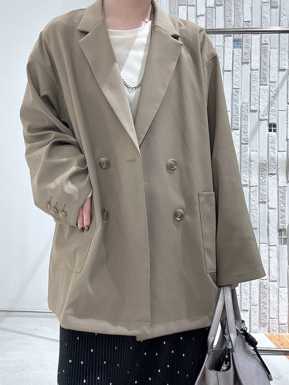 ホワイト系のTシャツ/カットソー、ブラウン系のテーラードジャケット、その他のトートバッグを着用したレディースの春コーディネートの6枚目の写真