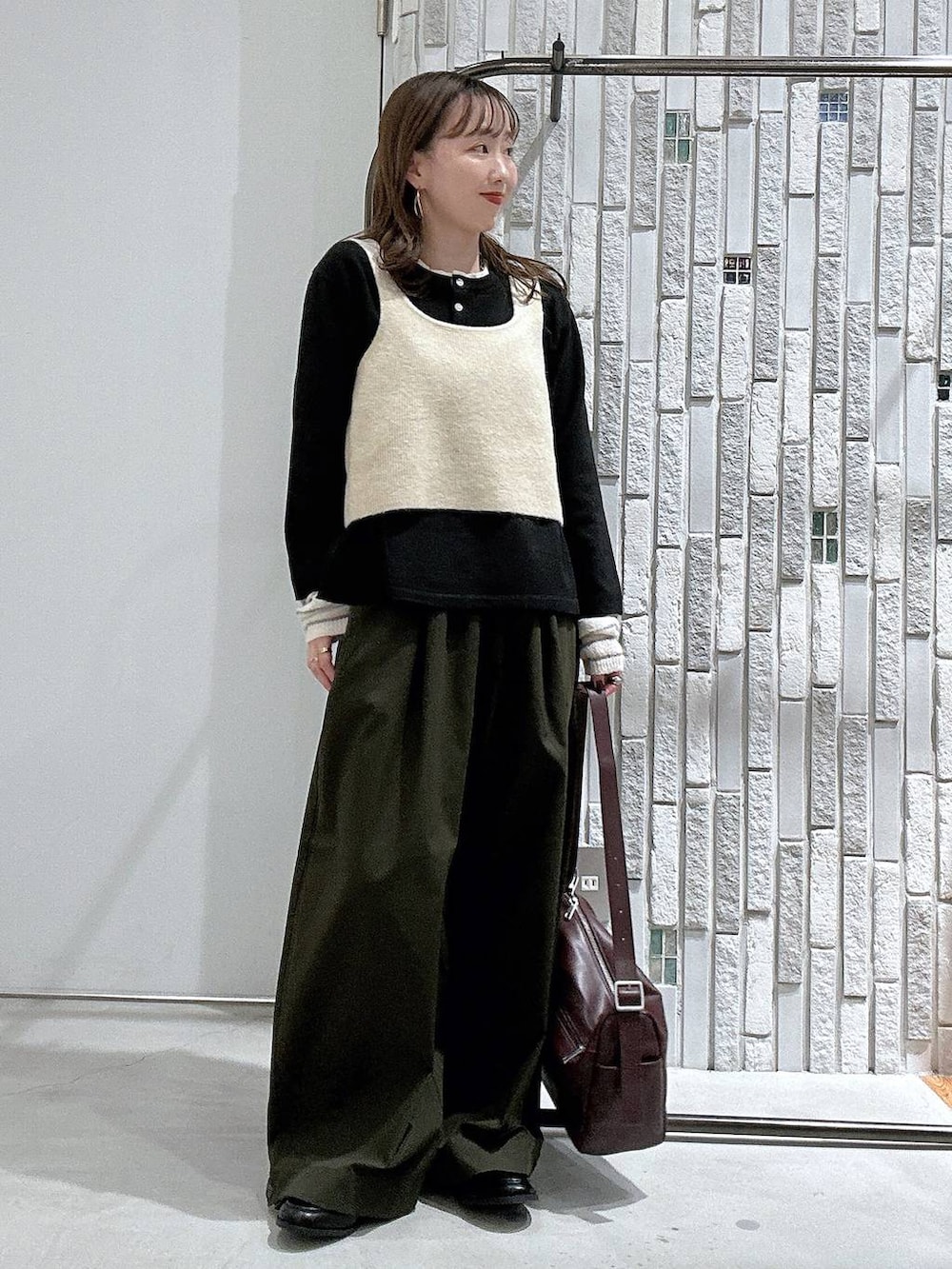 ブラック系のローファー、グリーン系のその他パンツ、ブラック系のニット/セーターを着用したレディースの秋コーディネートの2枚目の写真