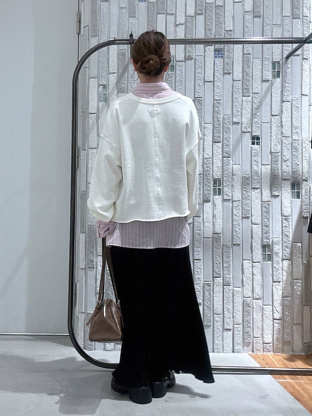 ブラック系のサンダル、ブラウン系のボストンバッグ、ピンク系のシャツ/ブラウスを着用したレディースの冬コーディネートの5枚目の写真