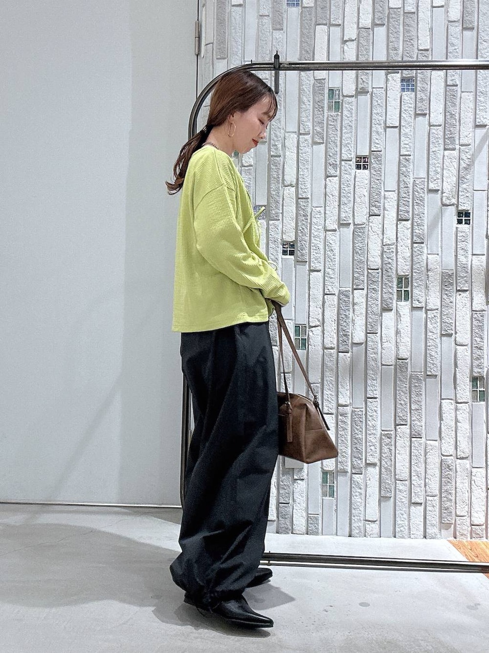 ブラウン系のボストンバッグ、ホワイト系のTシャツ/カットソー、グレー系のその他パンツを着用したレディースの春コーディネートの3枚目の写真