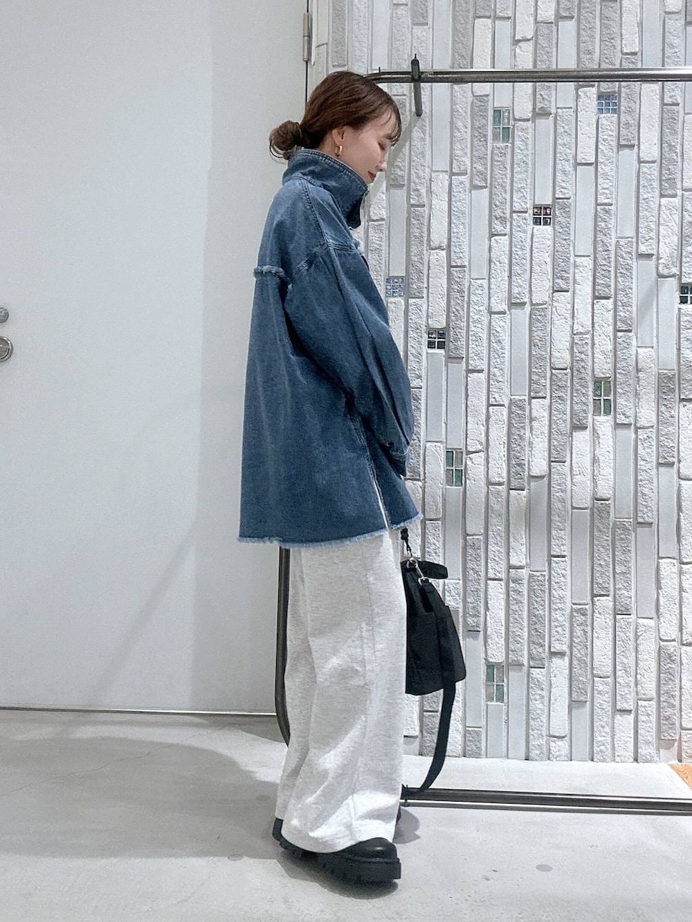 イエロー系のTシャツ/カットソー、ブルー系のシャツ/ブラウス、ブラック系のショルダーバッグを着用したレディースの冬コーディネートの4枚目の写真