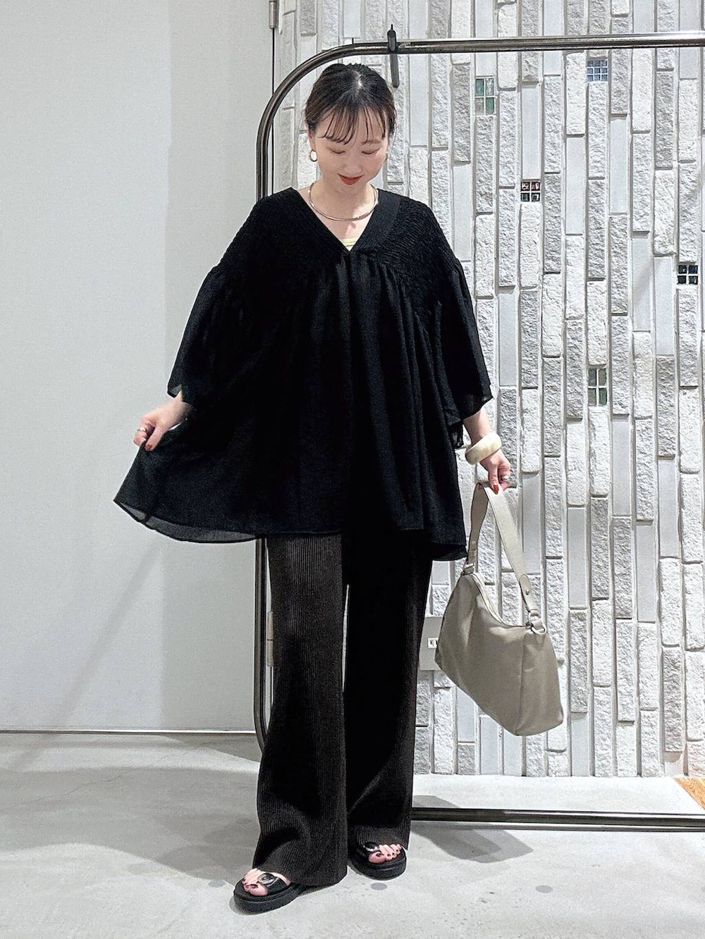 ブラウン系のその他パンツ、ブラック系のサンダル、ブラック系のシャツ/ブラウスを着用したレディースの夏コーディネートの2枚目の写真