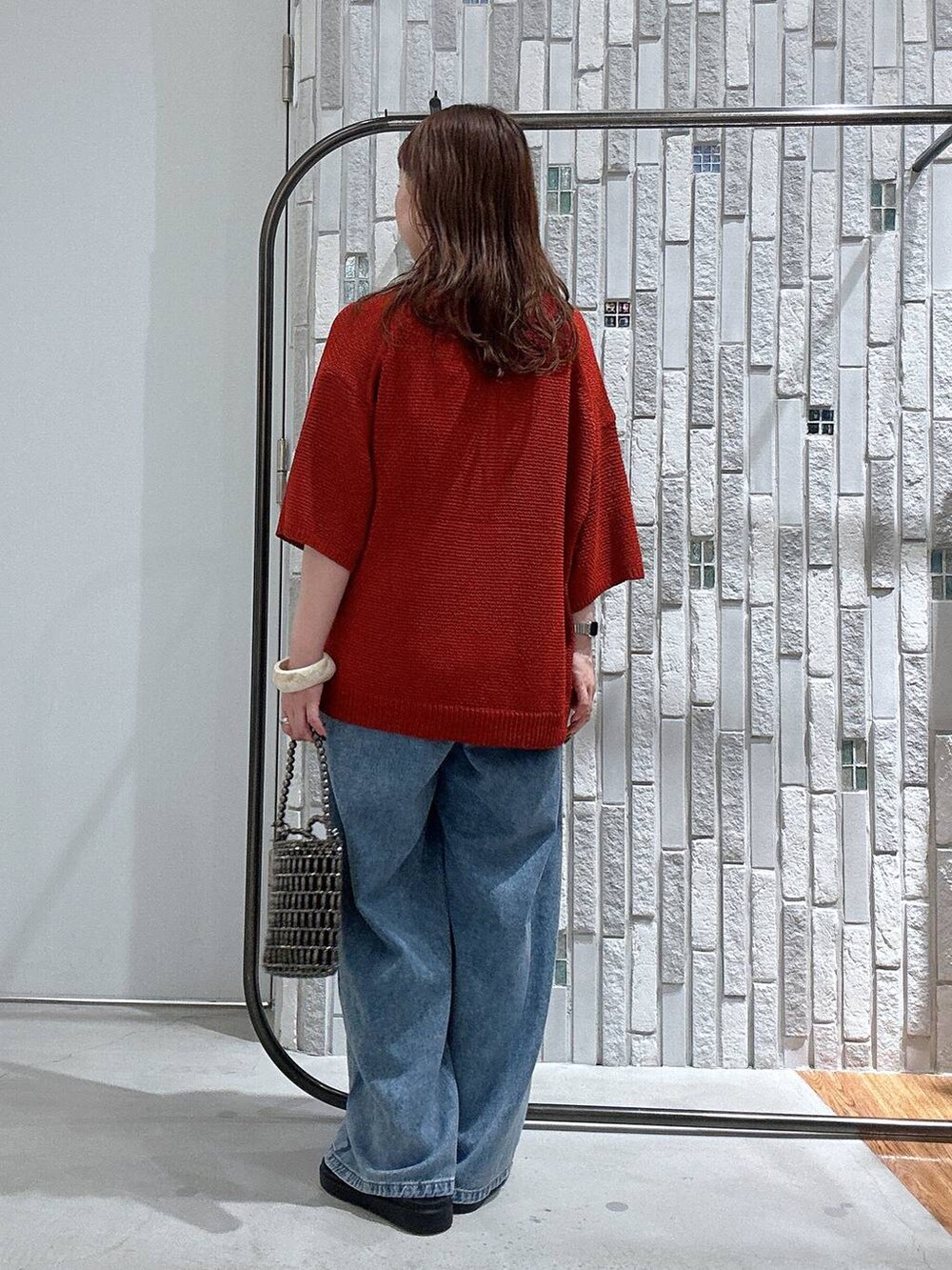 ブラウン系のサンダル、シルバー系のショルダーバッグ、ブルー系のデニムパンツを着用したレディースの夏コーディネートの4枚目の写真