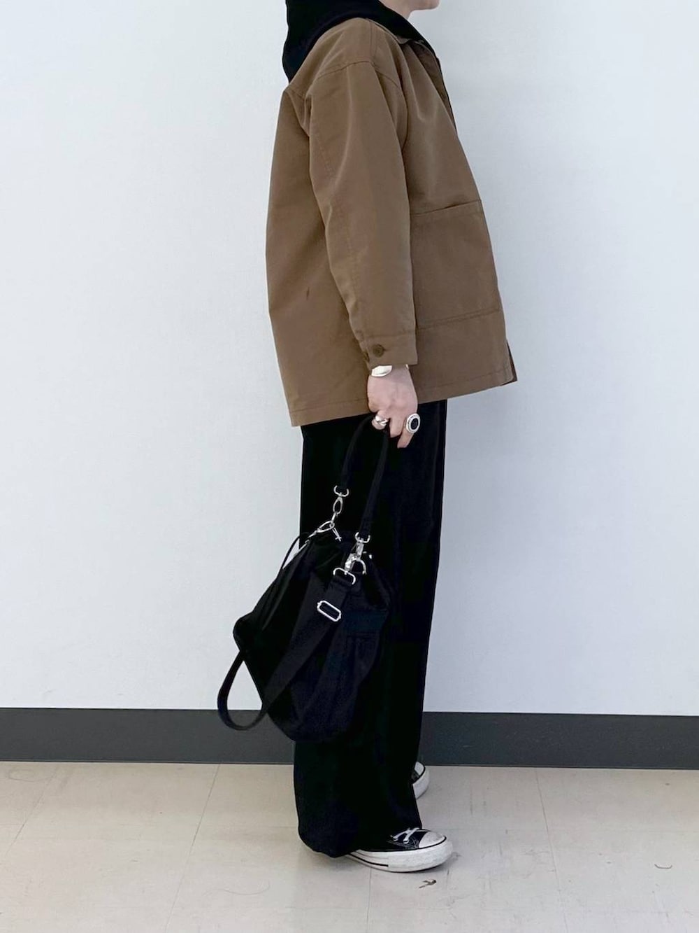 ブラック系のショルダーバッグ、ブラック系のその他パンツ、ブラウン系のデニムジャケットを着用したレディースの春コーディネートの4枚目の写真