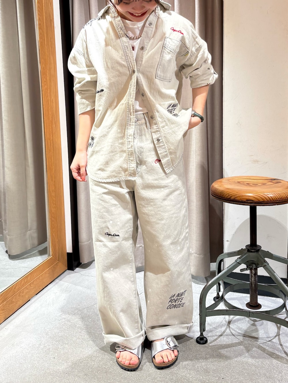 グレー系のシャツ/ブラウス、グレー系のデニムパンツ、シルバー系のサンダルを着用したレディースの夏コーディネートの2枚目の写真