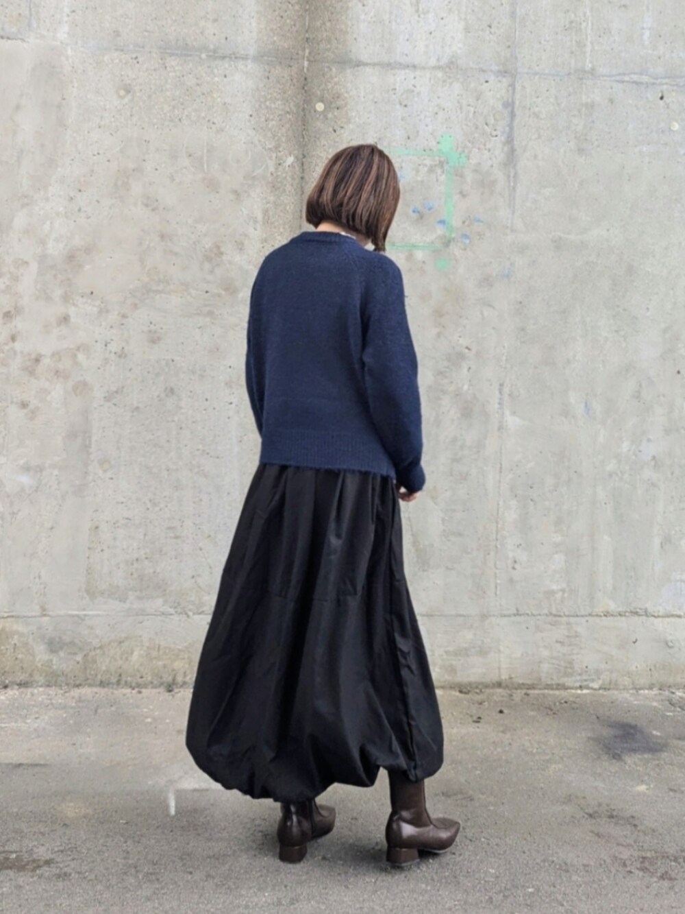 ブルー系のカーディガン/ボレロ、ブラック系のスカート、ホワイト系のシャツ/ブラウスを着用したレディースの秋コーディネートの2枚目の写真