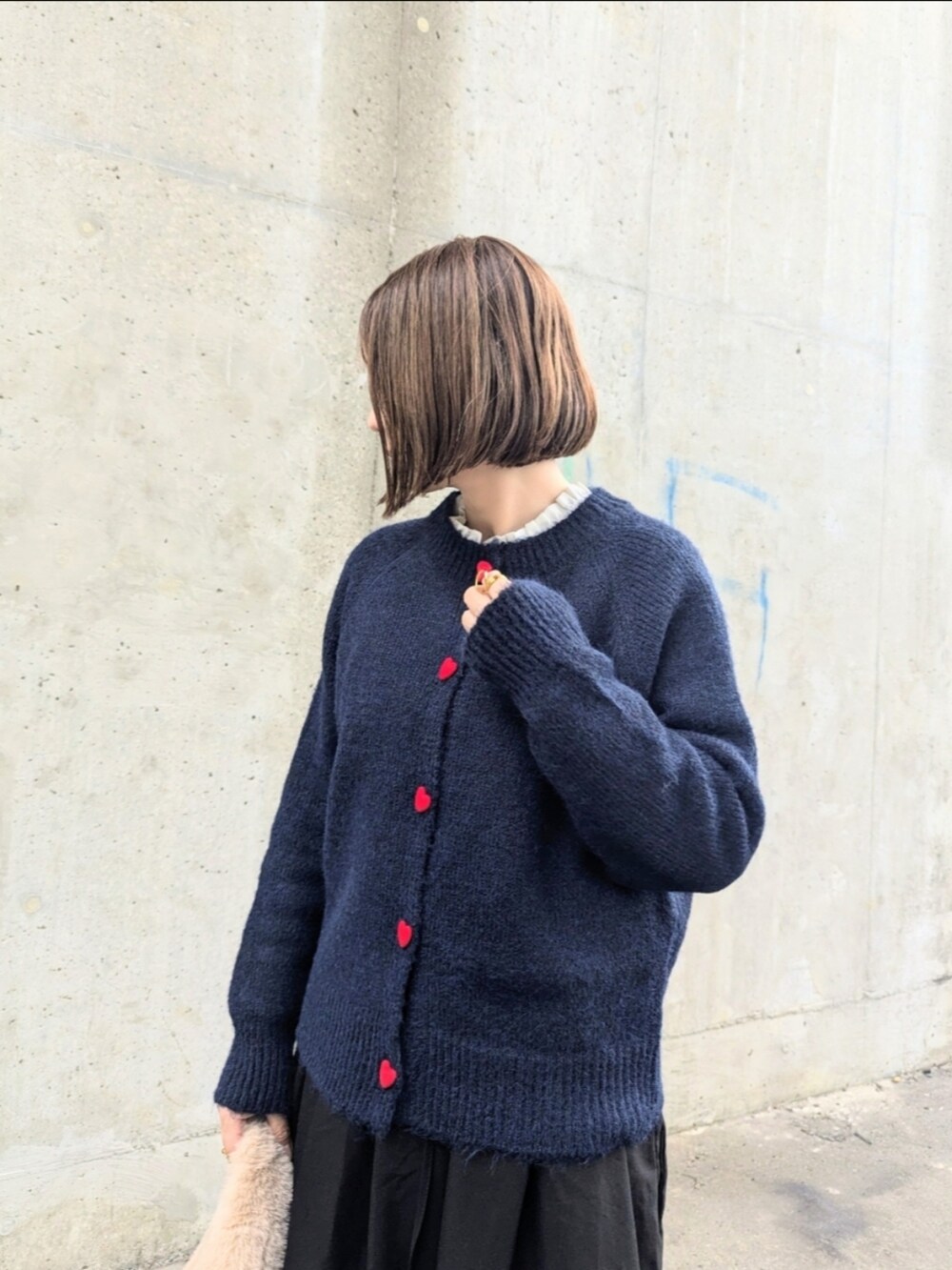 ブルー系のカーディガン/ボレロ、ブラック系のスカート、ホワイト系のシャツ/ブラウスを着用したレディースの秋コーディネートの3枚目の写真