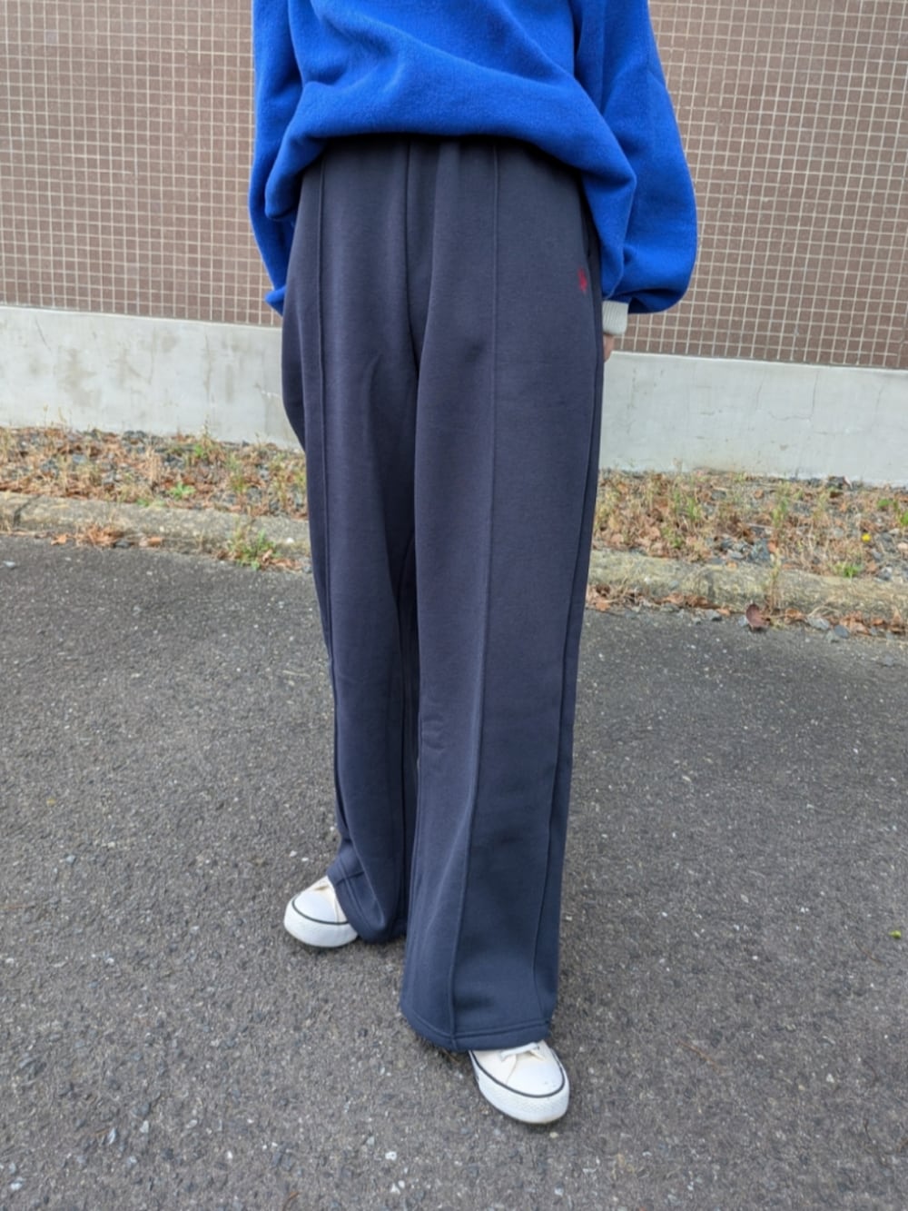 ブルー系のスウェットパンツ、ブルー系のニット/セーター、ホワイト系のトートバッグを着用したレディースの秋コーディネートの4枚目の写真