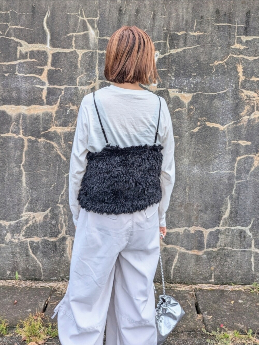 ブラック系のキャミソール、ベージュ系のカーゴパンツ、シルバー系のショルダーバッグを着用したレディースの秋コーディネートの3枚目の写真