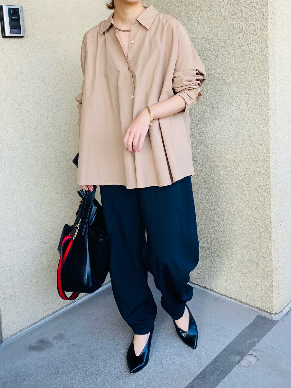 ブラック系のパンツ、ベージュ系のシャツ/ブラウス、ブラック系のパンプスを着用したレディースの秋コーディネートの3枚目の写真