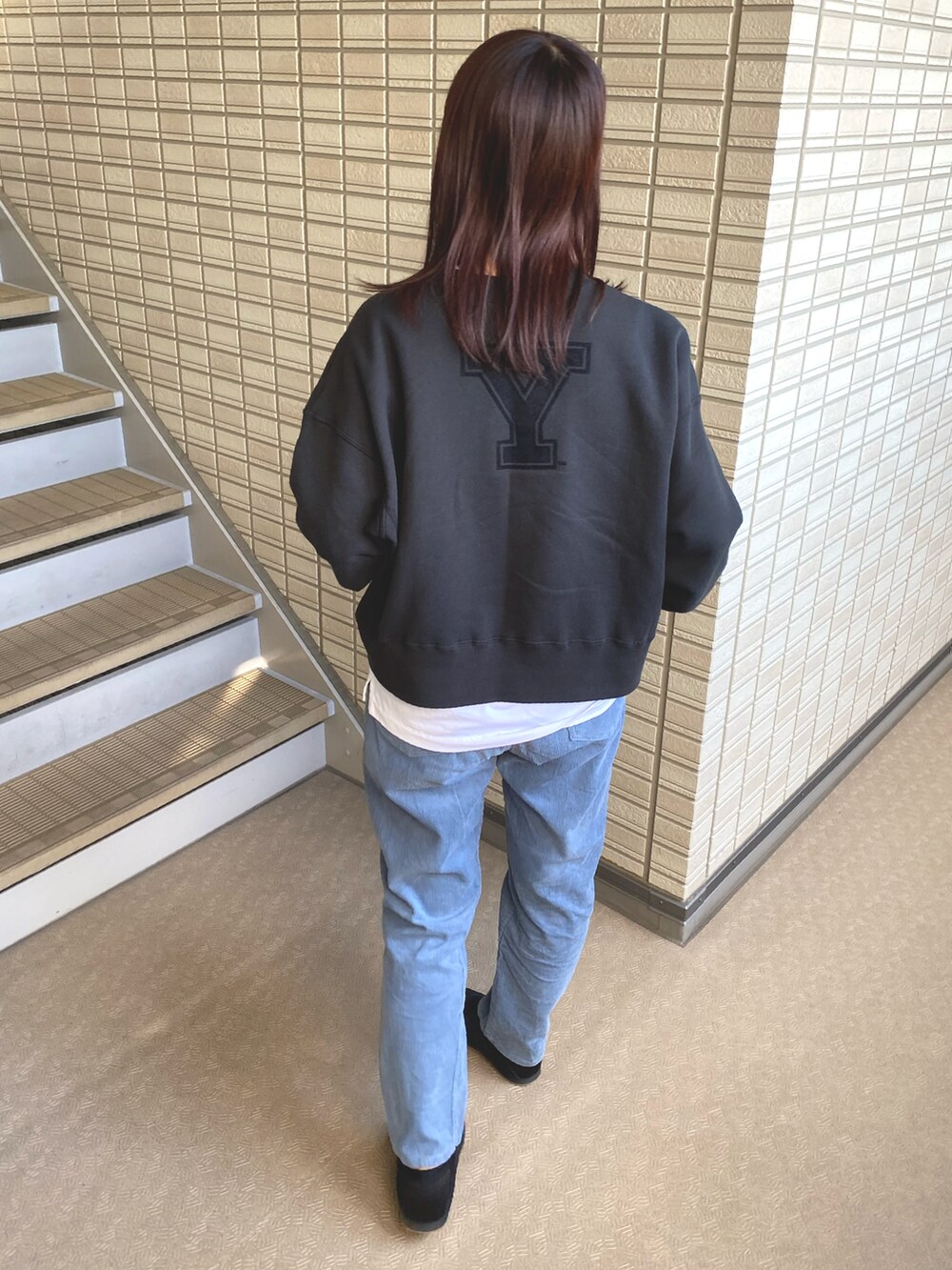 グレー系のカーディガン/ボレロ、ブルー系のその他パンツ、ブラック系のスニーカーを着用したレディースの冬コーディネートの2枚目の写真