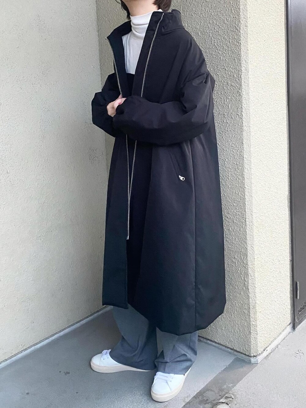 ホワイト系のニット/セーター、ブラック系のその他トップス、ベージュ系のパンツを着用したレディースの冬コーディネートの3枚目の写真