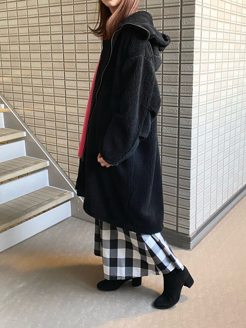 ピンク系のニット/セーター、ブラック系のその他アウター、ブラック系のスカートを着用したレディースの秋コーディネートの3枚目の写真