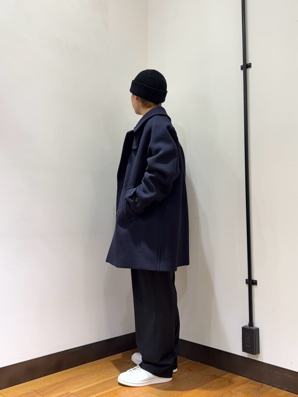 ブルー系のピーコート、グレー系のカーディガン/ボレロ、ブラック系のその他パンツを着用したメンズの冬コーディネートの2枚目の写真