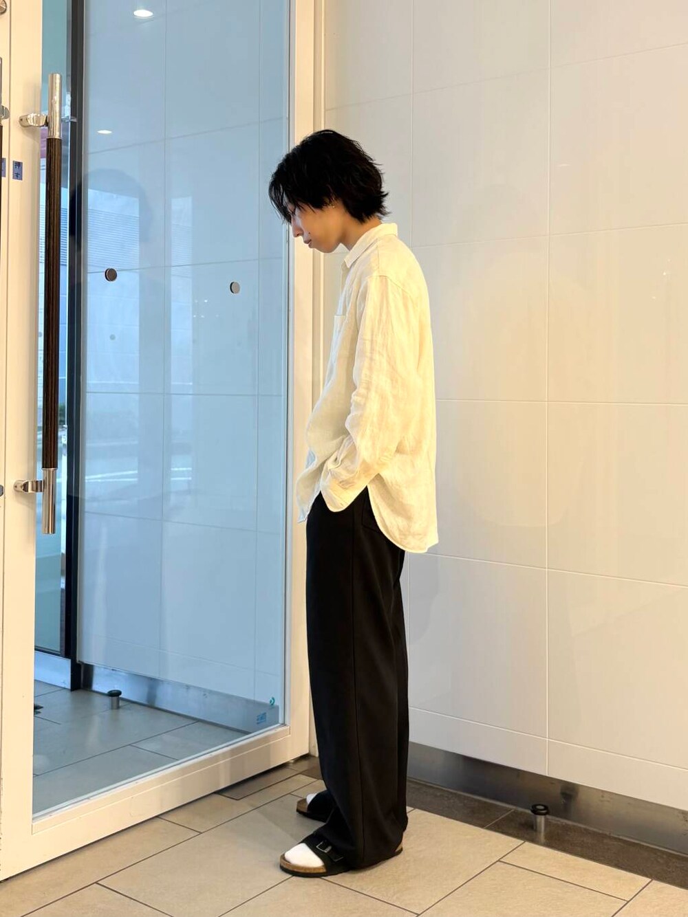 ブラック系のその他パンツ、ブラック系のサンダル、ホワイト系のシャツ/ブラウスを着用したメンズの夏コーディネートの2枚目の写真