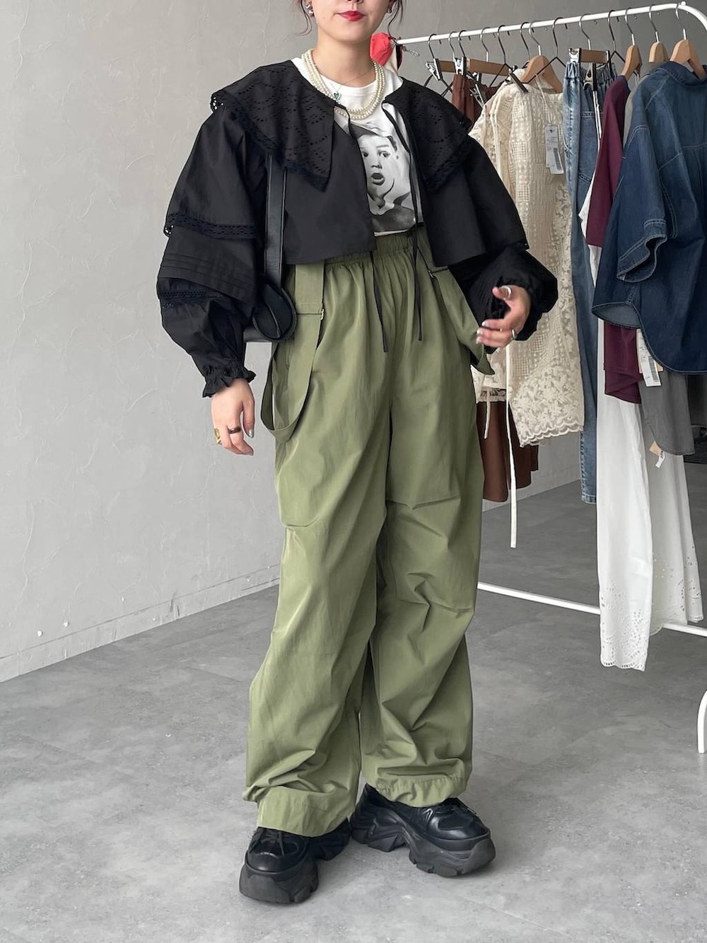 ブラック系のスニーカー、グリーン系のカーゴパンツ、ブラック系のショルダーバッグを着用したレディースの春コーディネートの6枚目の写真