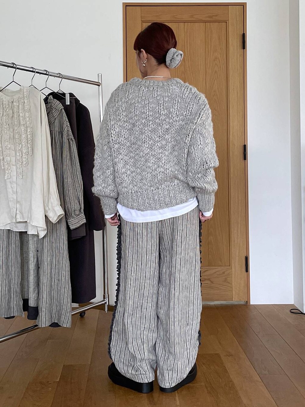 ブラック系のブーツ、その他のTシャツ/カットソー、グレー系のニット/セーターを着用したレディースの秋コーディネートの4枚目の写真