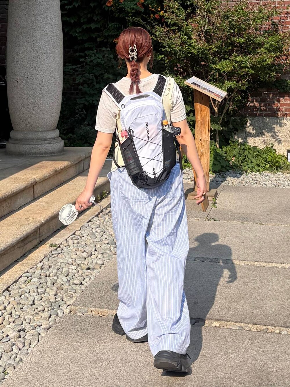 ブラック系のスニーカー、ホワイト系のタンクトップ、ブルー系のその他パンツを着用したレディースの夏コーディネートの3枚目の写真