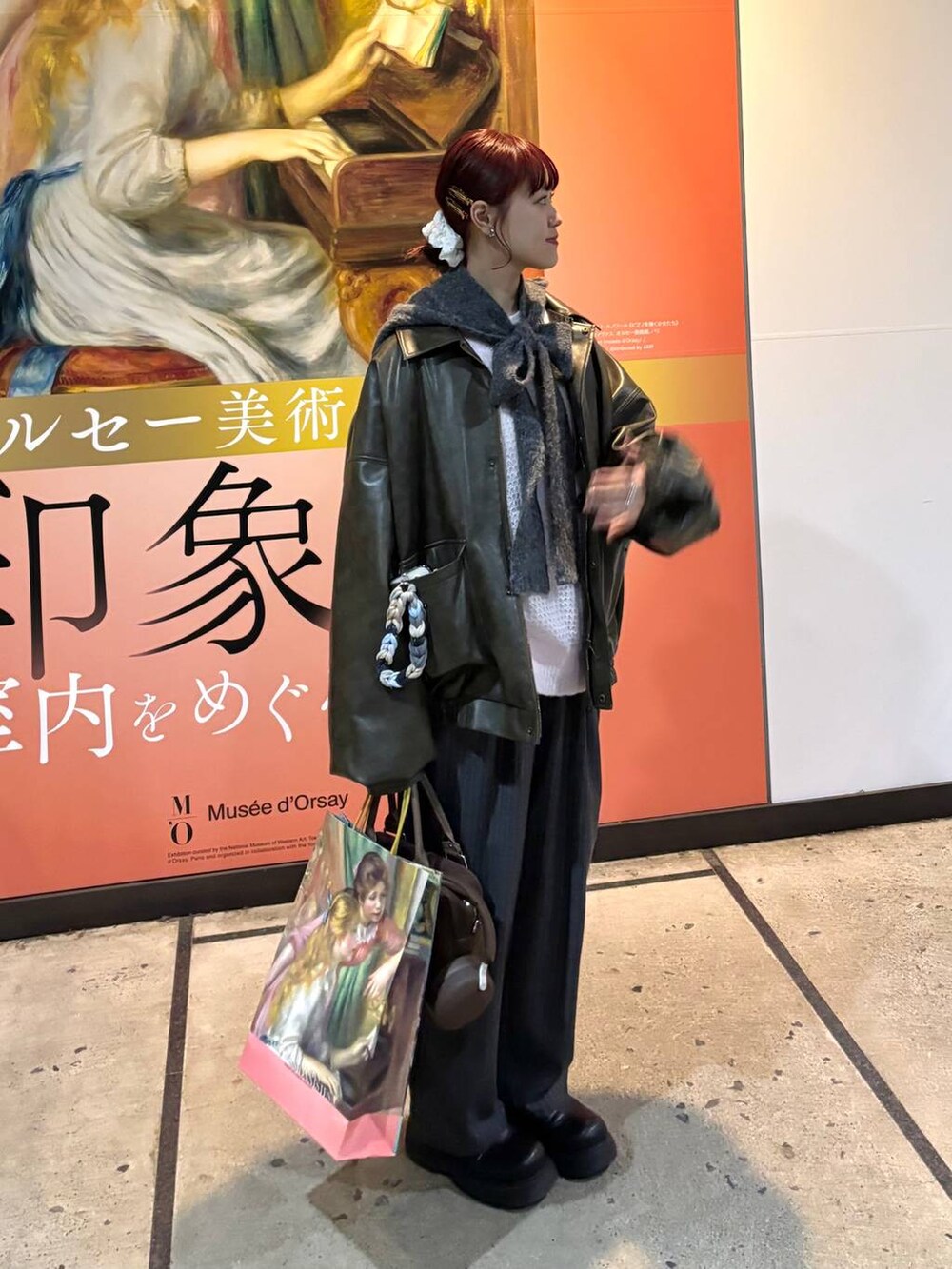 ピンク系のニット/セーター、グレー系のスラックス、グレー系のマフラーを着用したレディースの冬コーディネートの2枚目の写真