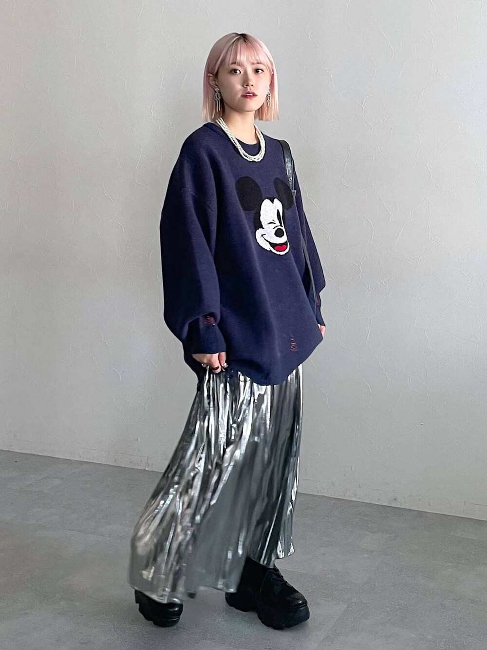 ブラック系のブーツ、ブラック系のショルダーバッグ、グレー系のスカートを着用したレディースの秋コーディネートの8枚目の写真