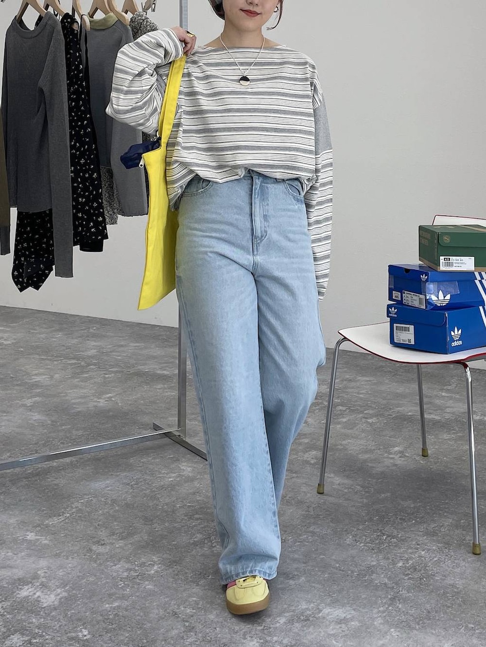 イエロー系のトートバッグ、ブルー系のデニムパンツ、グレー系のTシャツ/カットソーを着用したレディースの冬コーディネートの4枚目の写真