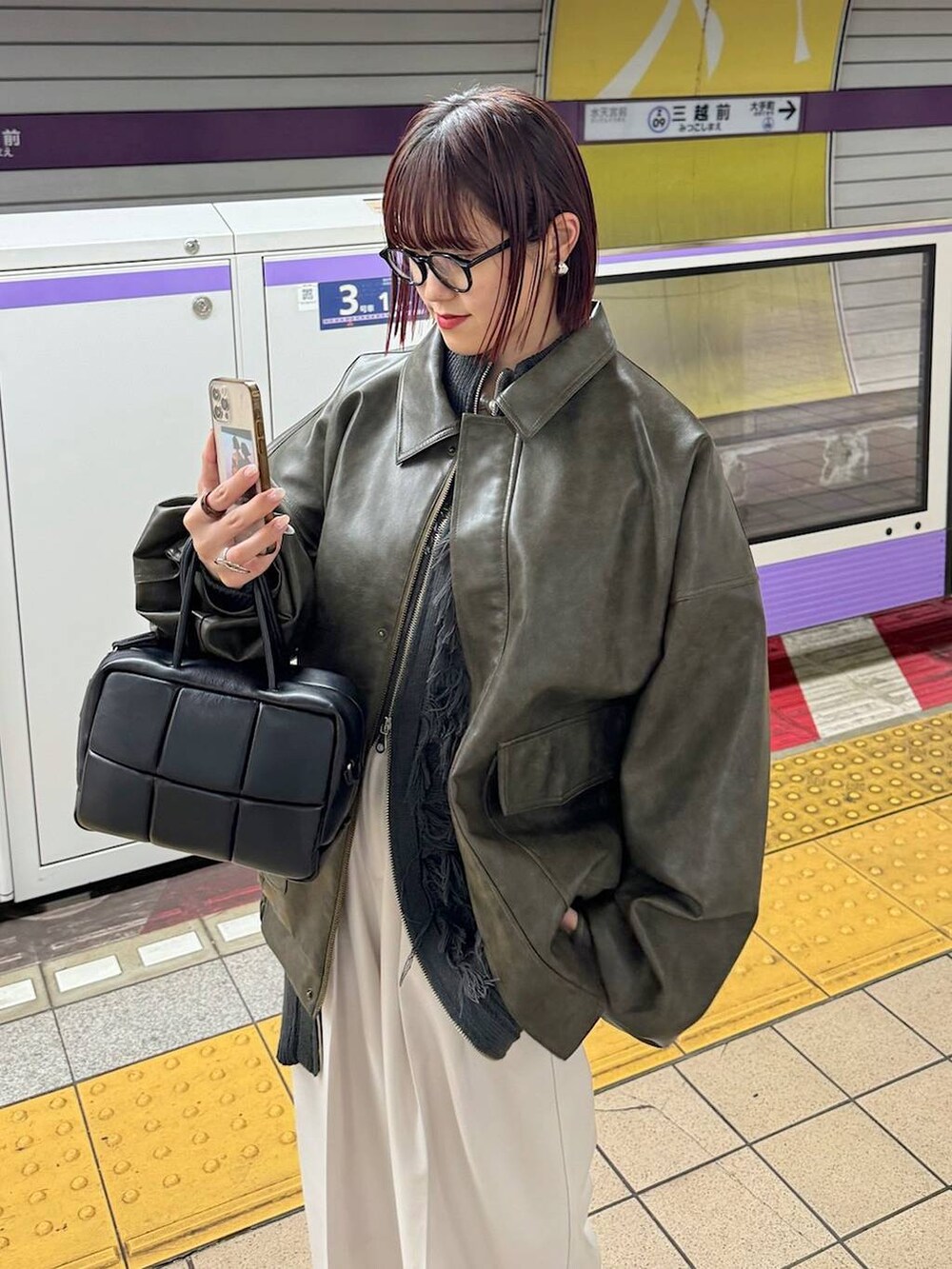 ブラウン系のブルゾン、ベージュ系のスラックス、グレー系のニット/セーターを着用したレディースの秋コーディネートの5枚目の写真