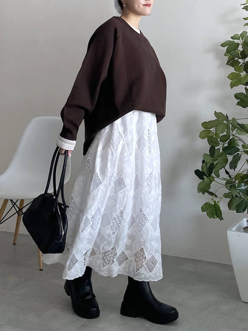 ホワイト系のTシャツ/カットソー、グレー系のニット/セーターを着用したレディースの秋コーディネートの4枚目の写真