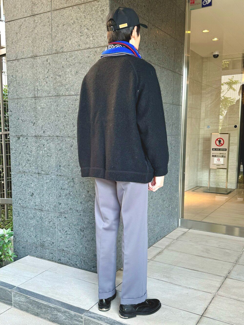 ブラック系のニット/セーター、グレー系のその他パンツ、ブラック系のドレスシューズを着用したメンズの冬コーディネートの2枚目の写真