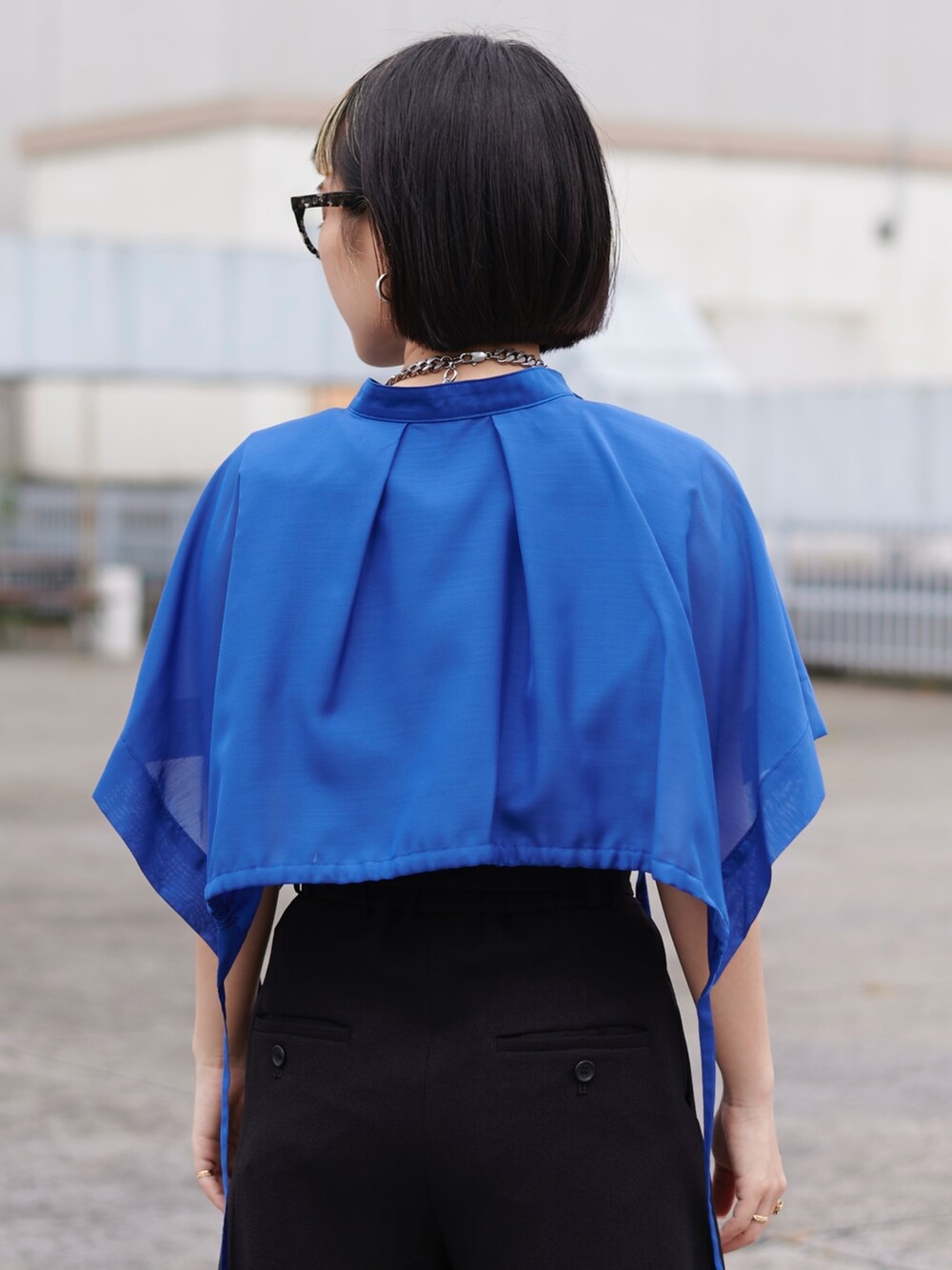 ブルー系のシャツ/ブラウス、ブラック系のスラックスを着用したレディースの春コーディネートの2枚目の写真