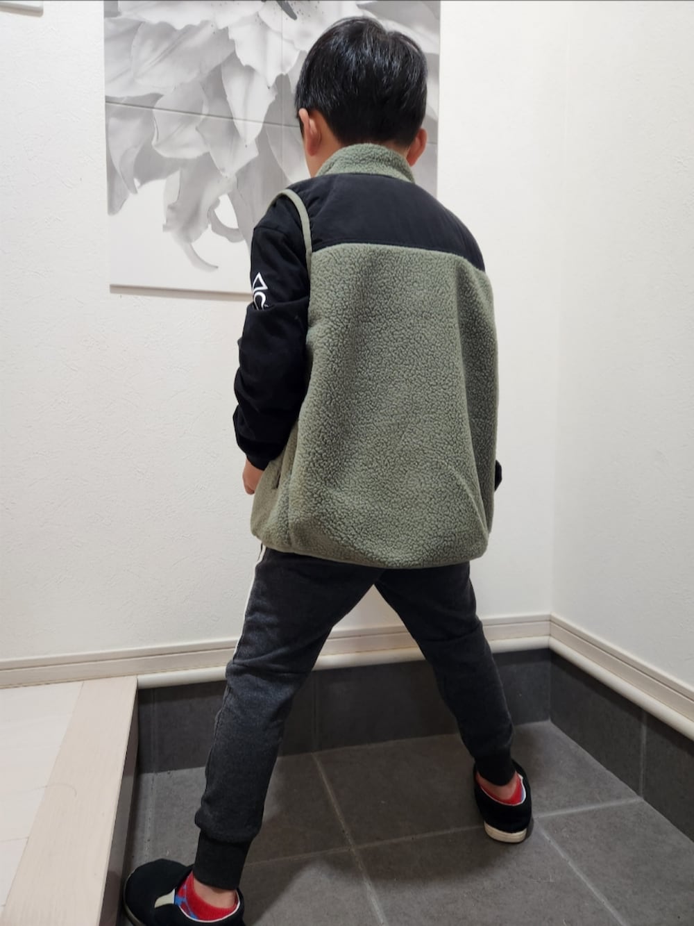 ブラック系のTシャツ/カットソー、グレー系のスウェットパンツ、ブラック系のスリッポンを着用したキッズの秋コーディネートの2枚目の写真