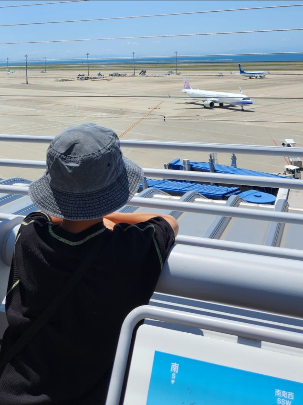 ブラック系のTシャツ/カットソー、ベージュ系のその他パンツ、ベージュ系のスニーカーを着用したキッズの春コーディネートの2枚目の写真