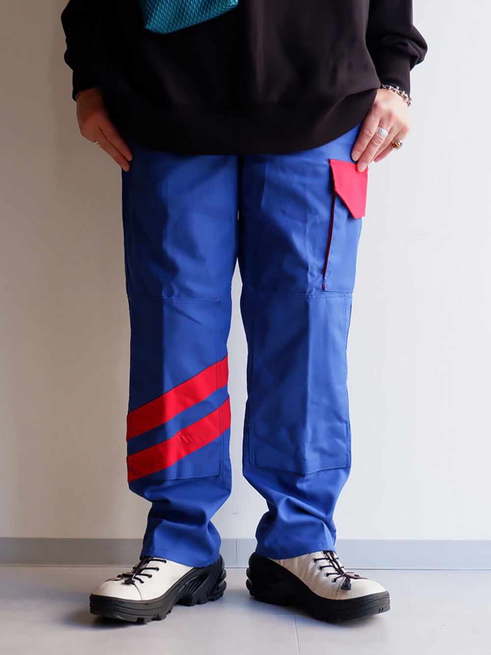 ブルー系のパンツ、ブラック系のスウェット、ホワイト系のブーツを着用したメンズの夏コーディネートの2枚目の写真