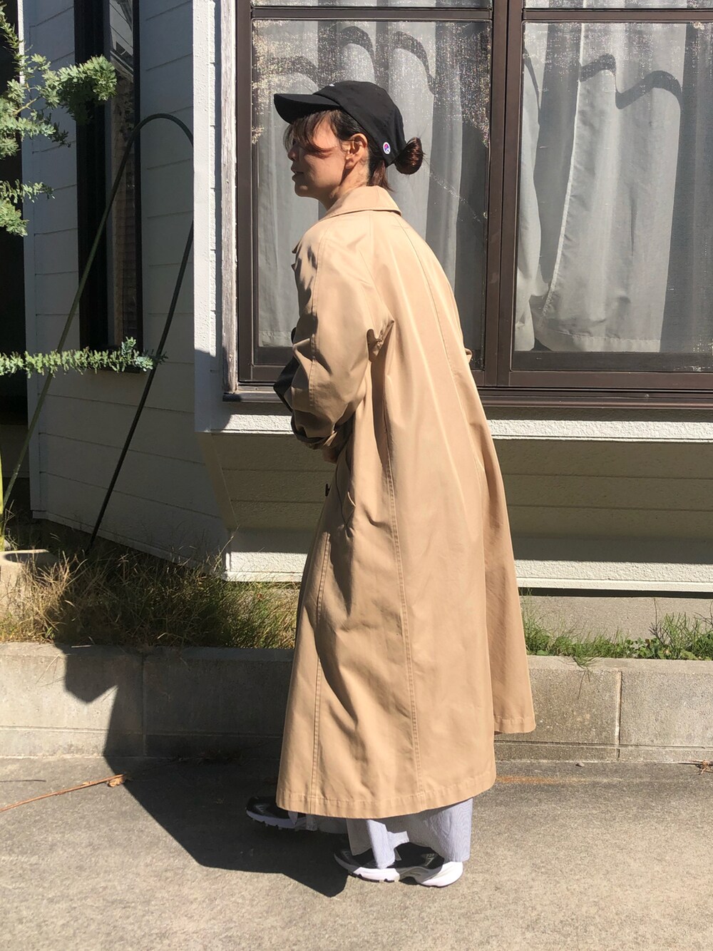 グレー系のワンピース、ブラック系のスニーカーを着用したレディースの秋コーディネートの3枚目の写真