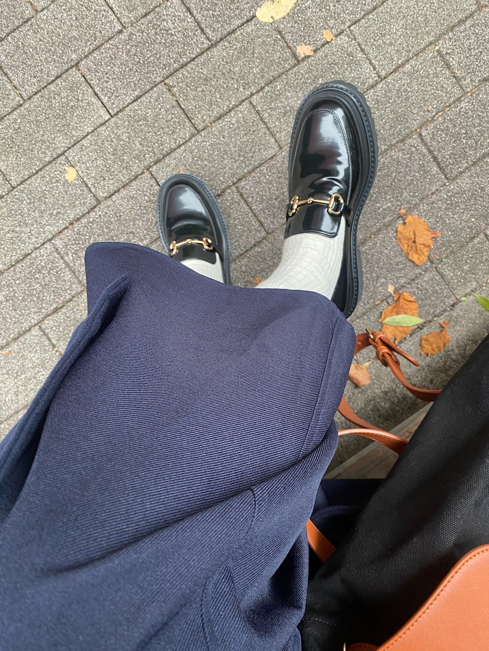 ブラック系のローファー、ブルー系のセットアップ、ブルー系のピーコートを着用したレディースの秋コーディネートの2枚目の写真