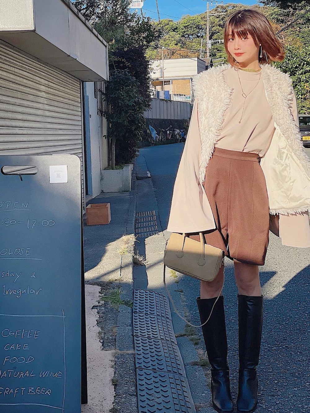 ホワイト系のベスト、ベージュ系のトップス、グリーン系のTシャツ/カットソーを着用したレディースの冬コーディネートの3枚目の写真